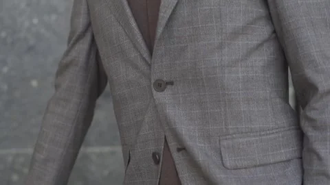 A man in a solid suit and glasses stands on the street Video stock 264478120