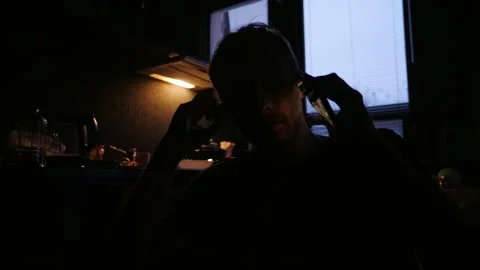 Man solves his problems by talking on the phone in a dark room  Stock Footage 168037737