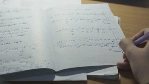 The man solves mathematical problems in a notebook and prepares for training Video stock 131527902