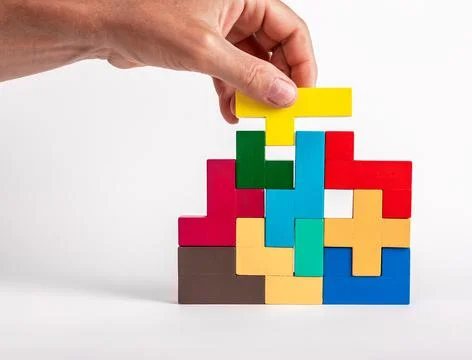 Man solving logical tetris puzzle, searching appropriate place for detail Stock Photos