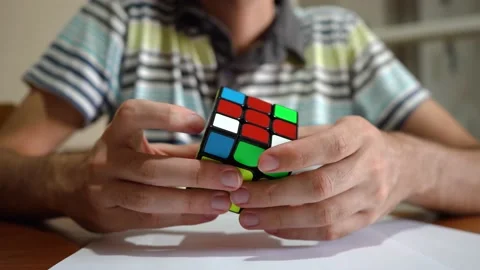 Man Solving Rubik's Cube - close up, selective focus Stock Footage 152583417