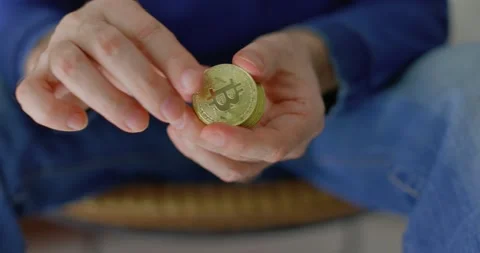 Man with some bitcoins in his hands in closeup Stock Footage 238768428