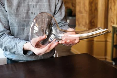 Man sommelier presenting empty elegant phallic glass decanter Stock-Fotos