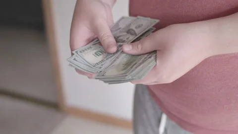 Man sorting $100 USD dollar bills in 4k Stock Footage 137665719