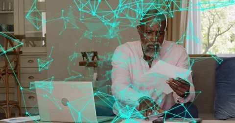 Man sorting docs on couch after checking laptop, calling while teal network Stock Footage 322203153