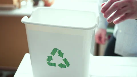  Man sorting plastic bottles and paper waste into recycling bins at home kitchen Video stock 330886114
