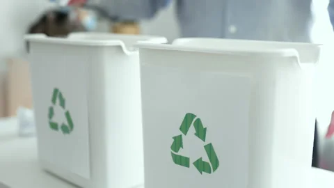  Man sorting plastic bottles and paper waste into recycling bins at home kitchen Video stock 330888371
