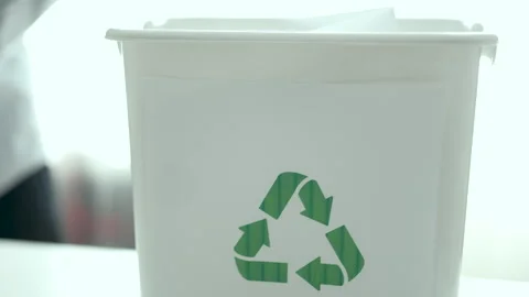 Man sorting plastic bottles and paper waste into recycling bins at home kitchen, Video stock 330888968