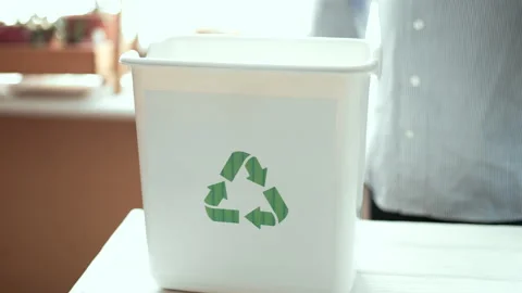 Man sorting plastic bottles and paper waste into recycling bins at home kitchen, Stock Footage 330889490