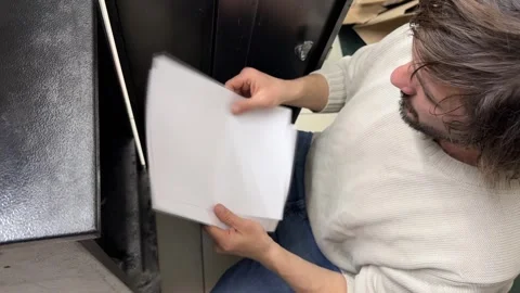 Man sorting through paper sheets, searching documents in archive, office and Stock Footage 337110628
