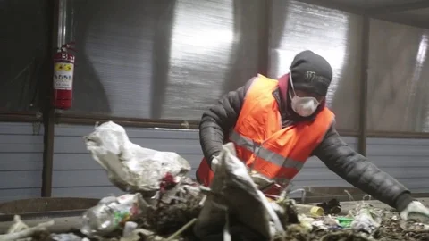 Man sorts garbage on the conveyor Stock Footage 82054236