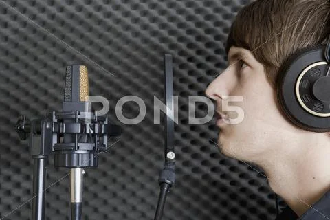 Man in sound booth of recording studio Stock Photos