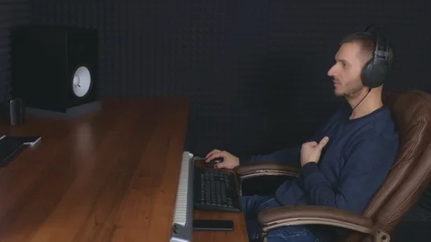 Man sound engineer in studio recording song and working on computer, side view. Stock Footage 119198153