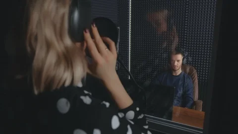 Man sound engineer in studio recording song of woman singer singing. Stock Footage 123566735