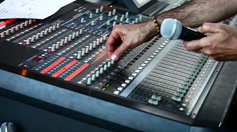 Man in sound studio setting a sound mixer console Stock Footage 36492872