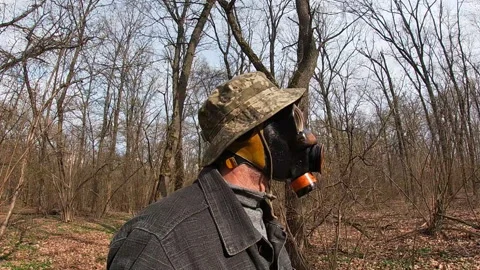 A man in a Soviet painted gas mask PMG Nerekhta, Panama pixel ZSU, Ukraine. Stock Footage 332616722