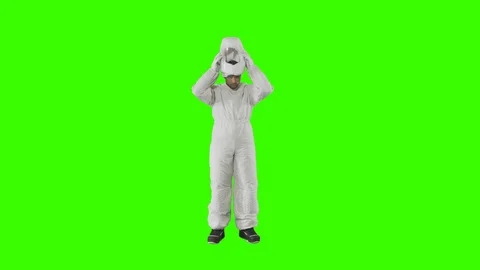 Man in a spacesuit stands and puts on a helmet Stock Footage 123742046