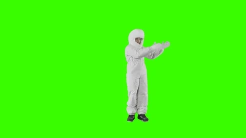 Man in a spacesuit stands and shows with both hands in opposite directions Stock Footage 123742093