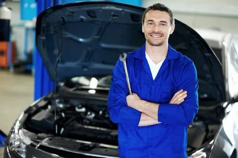 Man, spanner or mechanic in portrait with arms crossed, repair service or about  Stock Photos