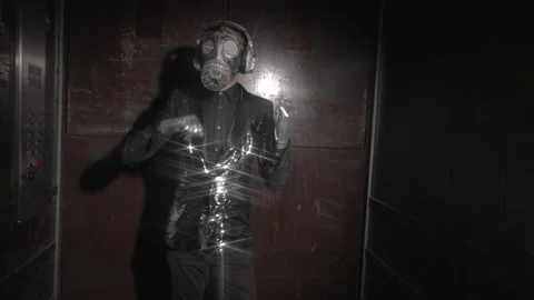 Man with sparkling gas mask dancing in a lift Stock Footage 154385652