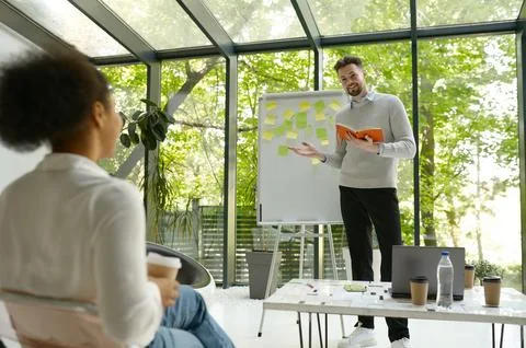 Man speaker presenting new project or marketing research results for colleague Stock Photos
