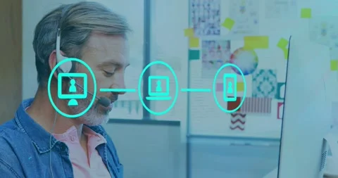 Man speaking into headset at desk pc icon appearing and starting teal support Stock Footage 333903320