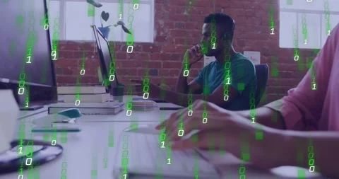 Man speaking on mic, pointing at tech monitor, causing binary code overlay as Stock Footage 332275447