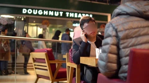 Man speaking by phone in cafe Stock Footage 81604586