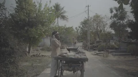 Man speaking on phone while selling on a cart, India Stock Footage 197479154
