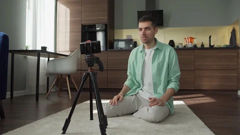 Man speaking at smartphone camera at home Stock Footage 128808489