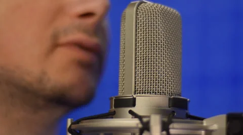 Man speaking into studio microphone. Close-up shot Stock Footage 39740611