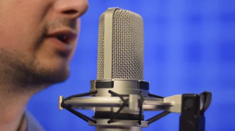 Man speaking into studio microphone Stock Footage 39740537