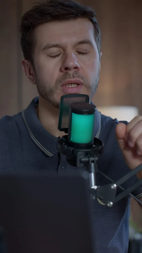 Man speaking into studio microphone in home podcast recording setup Stock Footage 331252853