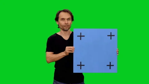 Man speaking while doing presentation with blank board on green screen Видео 130794376