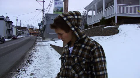 Man Speaks to the Camera Showing his Wallet on a Cold Snowy Day Stock Footage 154214286
