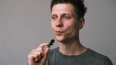 The man speaks into a lavalier microphone. Stock Footage 311570275