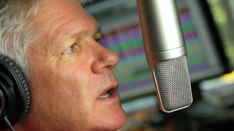 MAN SPEAKS INTO MICROPHONE Stock Footage 7847705