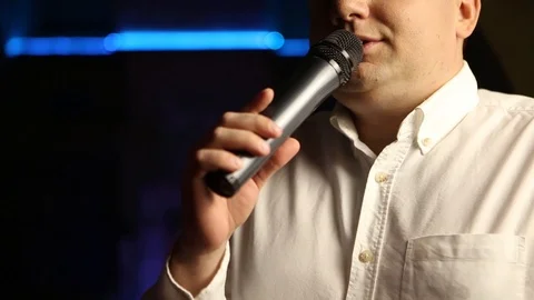 Man speaks into microphone Stock Footage 99932531