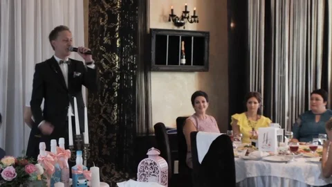 Man speaks into a microphone at a wedding Stock Footage 76489840