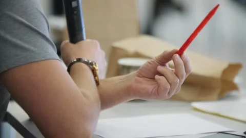 A man speaks into a microphone while holding a pen in his hand Video stock 257078579