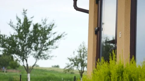 A man speaks by phone and comes from home Stock Footage