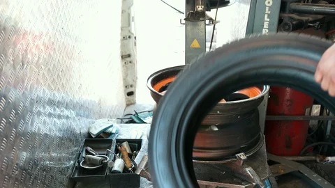 Man on special machine for tire, replacing the rubber on disc Stock-Footage 114980510