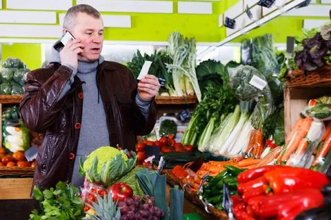 Man specifying shopping list in store Stock Photos