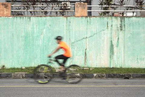 Man speeding on a bicycle with blur motion. Stock Photos