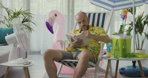 Man spending his vacations at home and reading a book Stock Footage 162385110