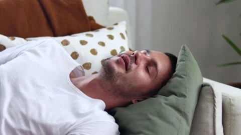 Man spending a lazy afternoonon sofa. Stock Footage 163084953