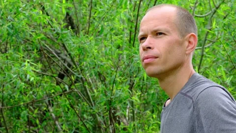 Man spending time outdoors. Portrait of a guy in the forest. Stock Footage 269675150