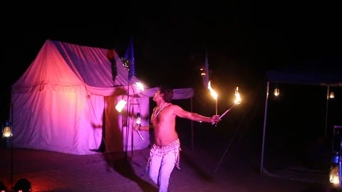Man Spewing Fire And Dancing IN A Show, Entertainment Stock Footage 94334390