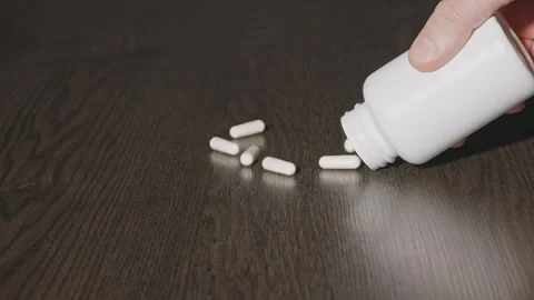 A man spilled tablets on the table Stock Footage 270413847