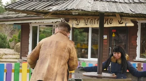 Man spin small carousel with lady slow motion Stock Footage 44047634